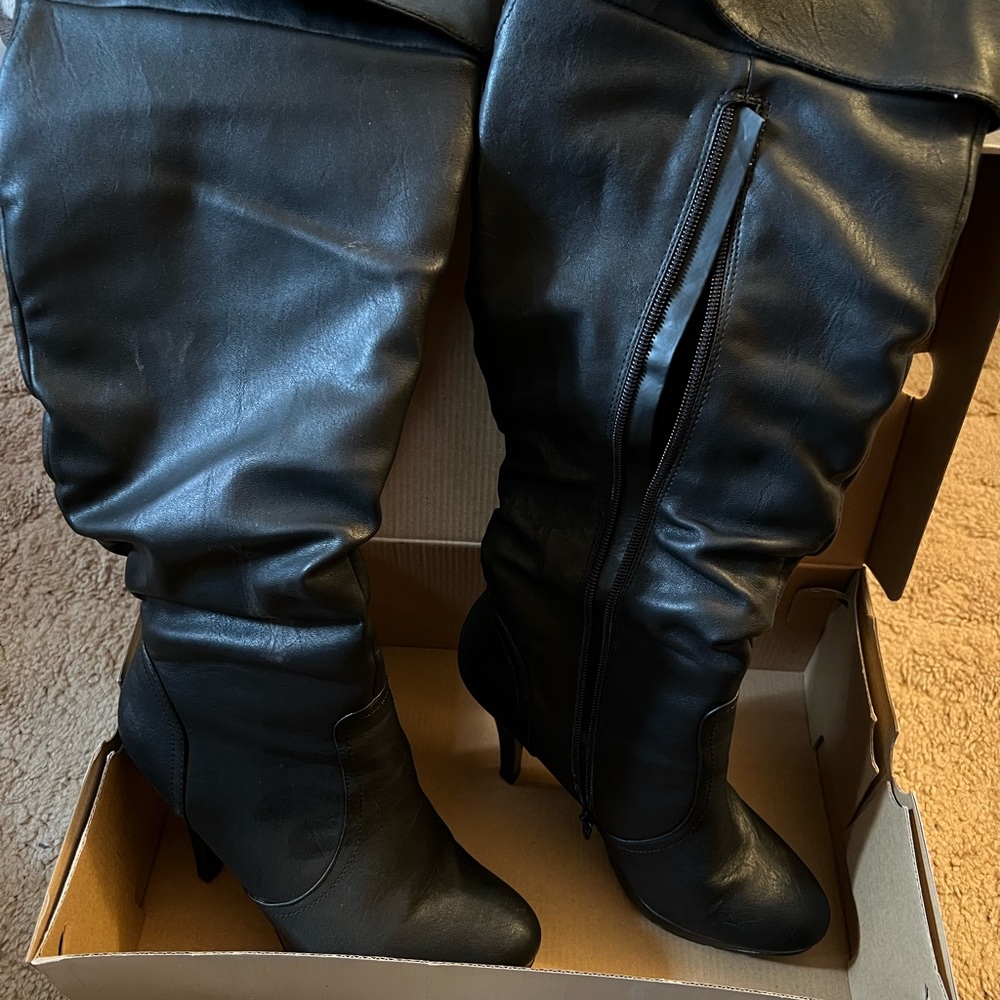 Knee high black leather heeled boots